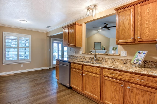 kitchen with light stone countertops, dishwasher, dark wood-type flooring, sink, and crown molding