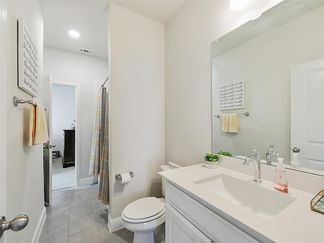 bathroom with toilet, tile patterned floors, and vanity