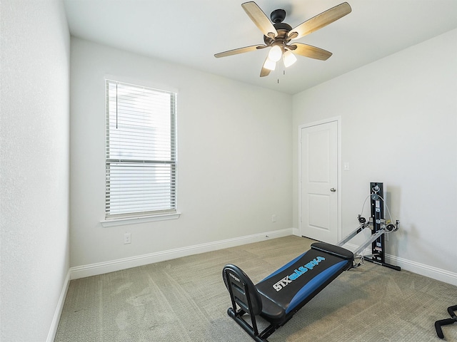 exercise room featuring ceiling fan and light colored carpet