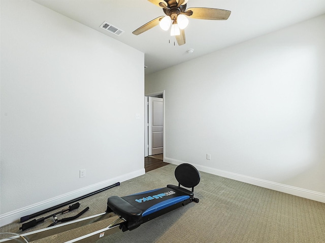 exercise room with ceiling fan and carpet