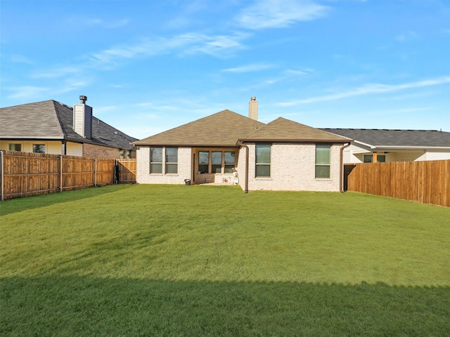 rear view of house with a yard