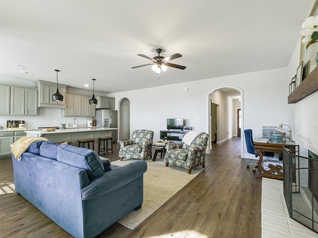 living room featuring light hardwood / wood-style floors and ceiling fan