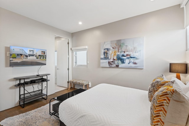 bedroom with dark hardwood / wood-style flooring