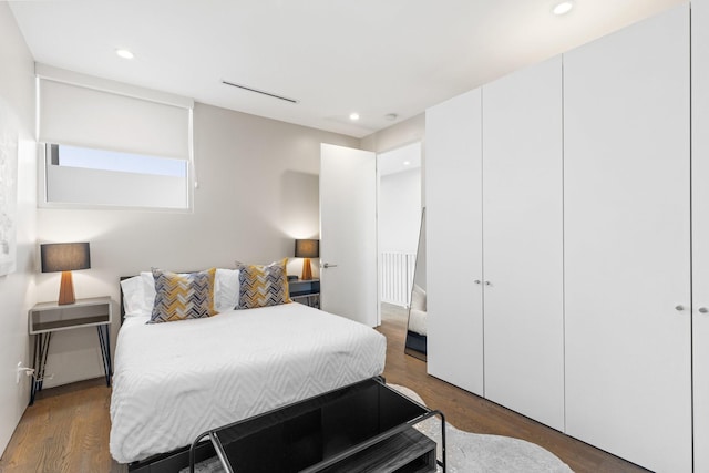 bedroom featuring dark hardwood / wood-style floors and a closet