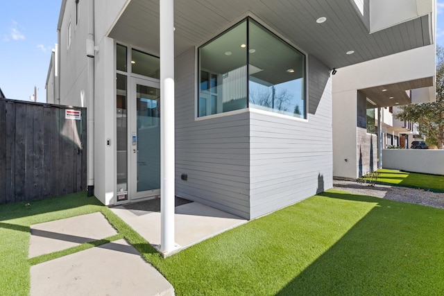 doorway to property featuring a yard