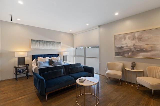 bedroom with dark hardwood / wood-style flooring