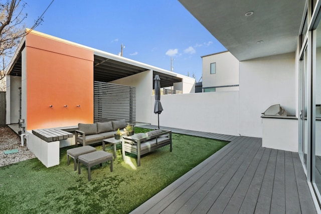 exterior space featuring an outdoor kitchen, an outdoor living space, and a lawn