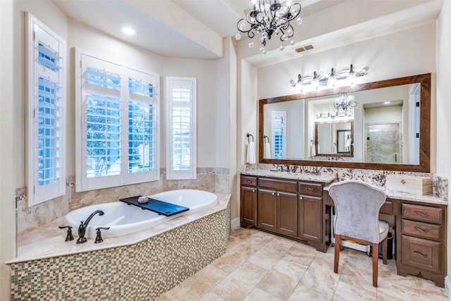 bathroom with vanity, a notable chandelier, and shower with separate bathtub