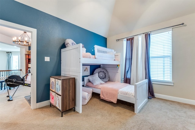 carpeted bedroom with an inviting chandelier, lofted ceiling, and multiple windows