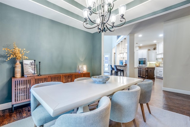 dining area featuring an inviting chandelier and dark hardwood / wood-style floors