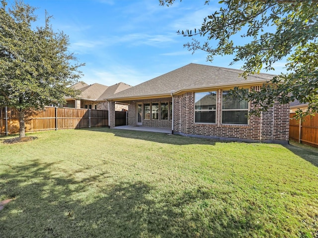 back of property featuring a yard and a patio