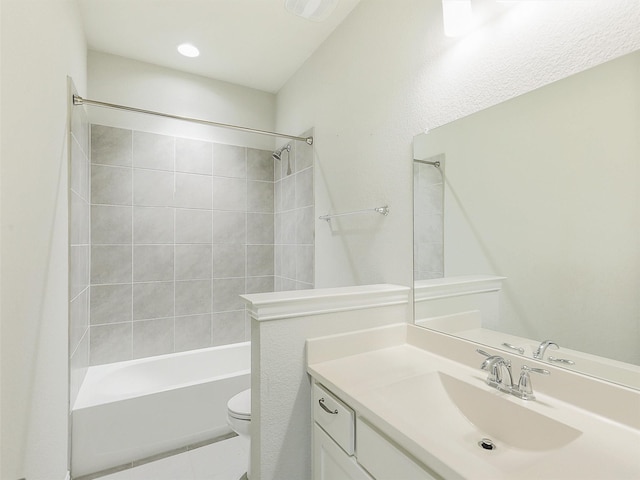 full bathroom with toilet, tiled shower / bath, and vanity