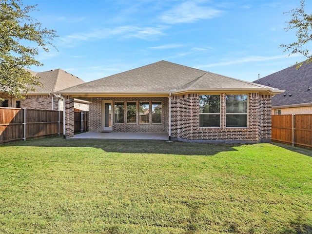 back of property with a patio and a lawn