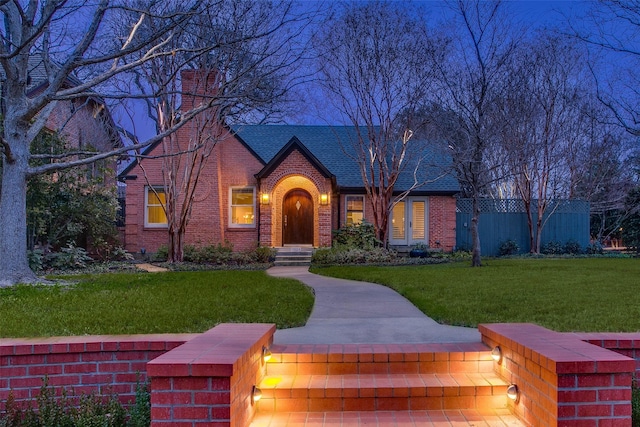 tudor house featuring a front yard