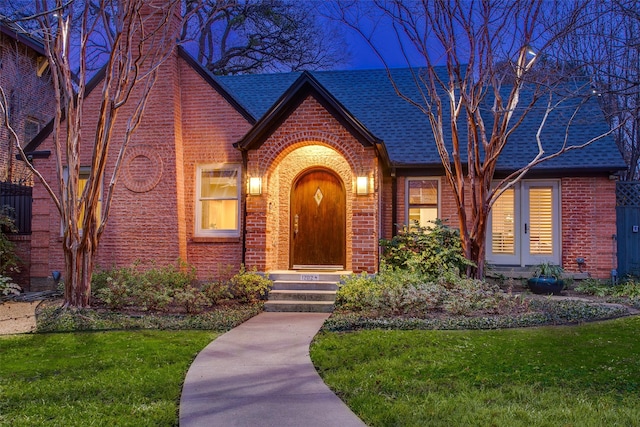 tudor-style house with a front lawn