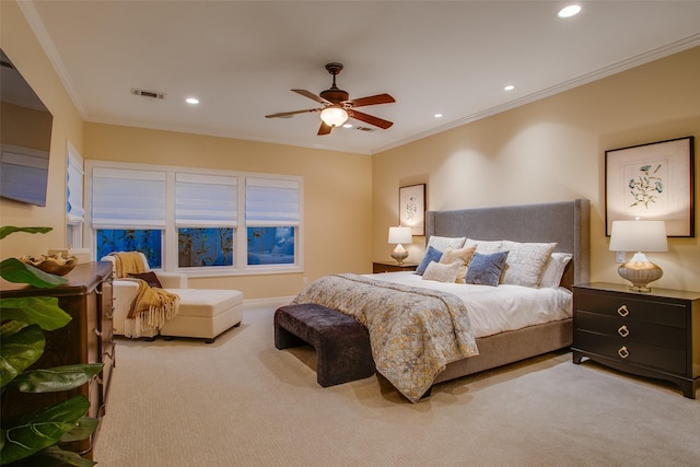 carpeted bedroom with ceiling fan and crown molding