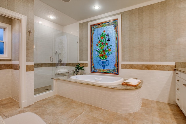 bathroom featuring vanity, tile walls, crown molding, and plus walk in shower