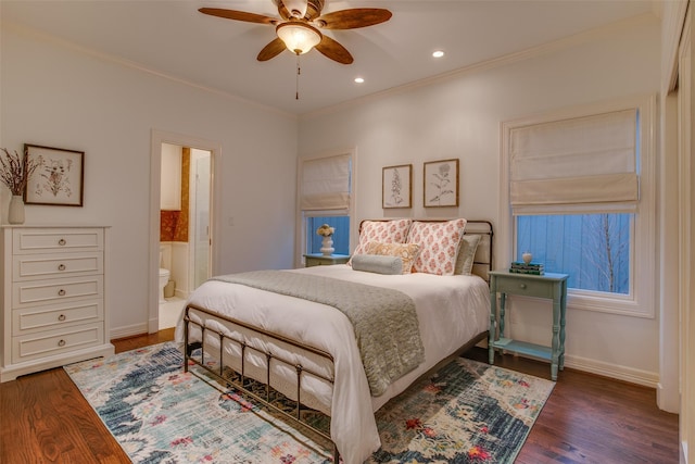 bedroom featuring ceiling fan, connected bathroom, crown molding, and dark hardwood / wood-style flooring