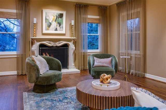 sitting room featuring ornamental molding and dark hardwood / wood-style floors