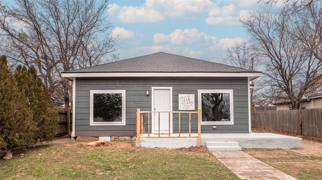 bungalow-style home with a front yard