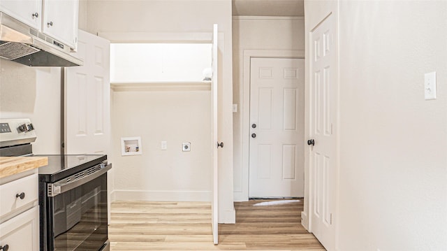 kitchen with white cabinetry, light hardwood / wood-style floors, and stainless steel range with electric cooktop