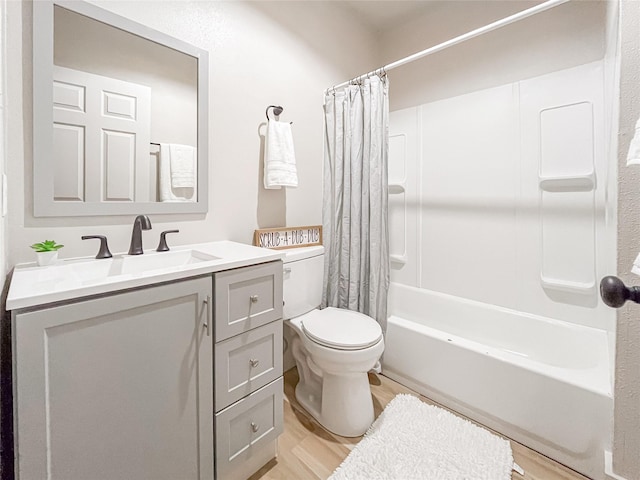 full bathroom featuring hardwood / wood-style flooring, toilet, shower / bath combination with curtain, and vanity