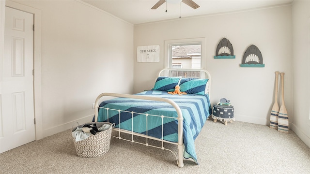 carpeted bedroom featuring ceiling fan and ornamental molding