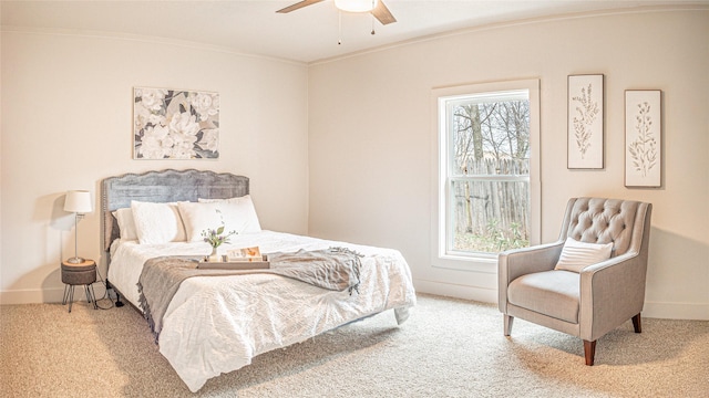 carpeted bedroom with ceiling fan, crown molding, and multiple windows