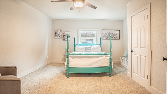 bedroom with ceiling fan, crown molding, and carpet flooring