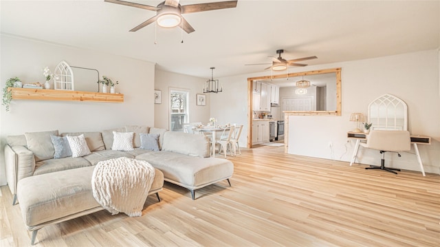 living room with light hardwood / wood-style floors and ceiling fan