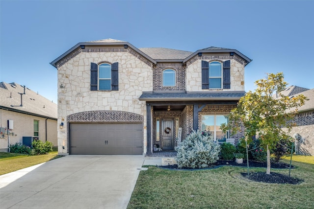 view of front of house featuring a garage, central AC unit, and a front yard