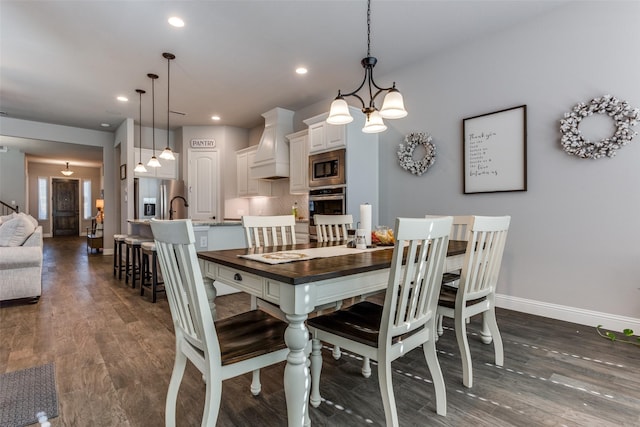 dining room with sink and dark hardwood / wood-style floors