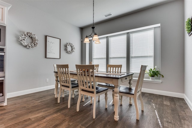 dining room featuring a wealth of natural light and dark hardwood / wood-style flooring