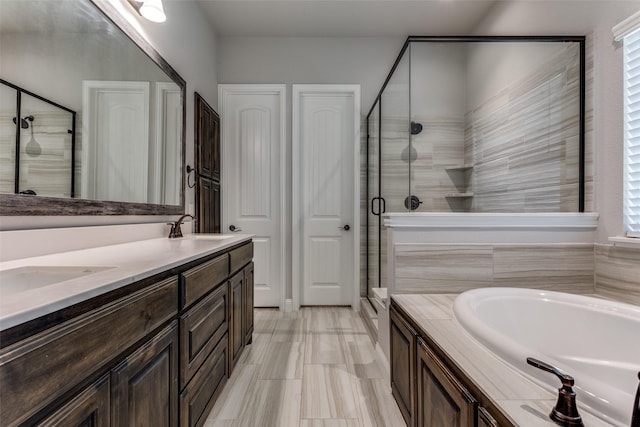 bathroom featuring vanity and separate shower and tub