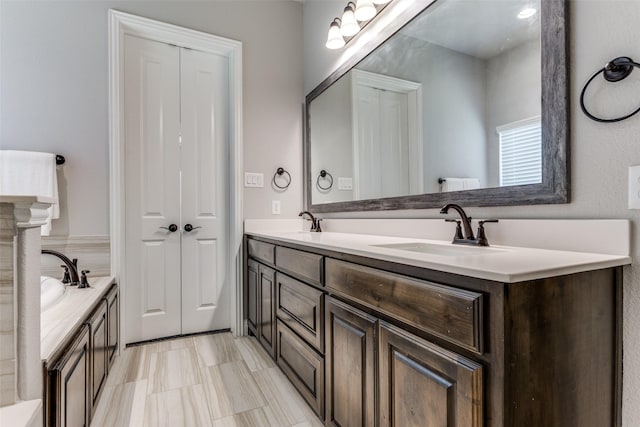 bathroom with a washtub and vanity