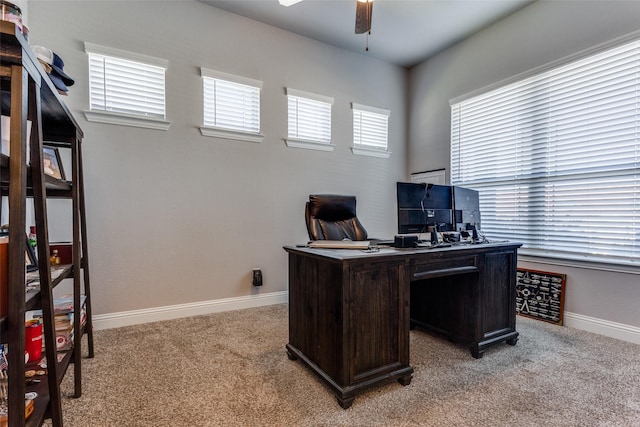 office area featuring ceiling fan, a wealth of natural light, and light carpet