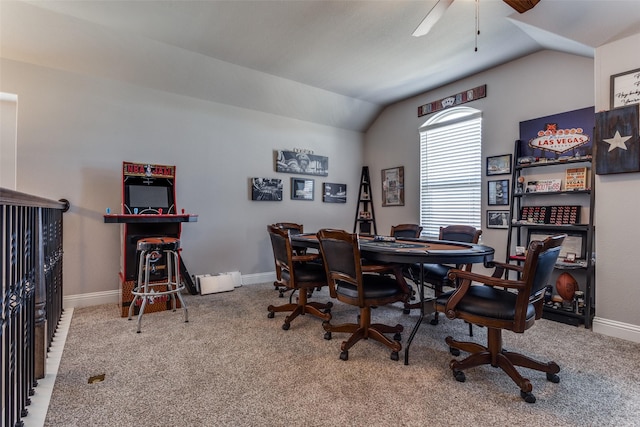 carpeted office space featuring vaulted ceiling and ceiling fan