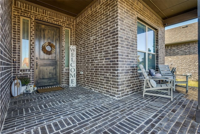 view of exterior entry with a porch