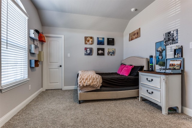 bedroom with light colored carpet and vaulted ceiling