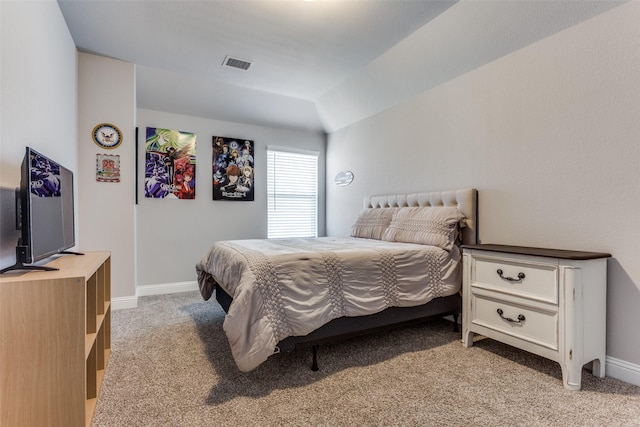 bedroom featuring light colored carpet and lofted ceiling