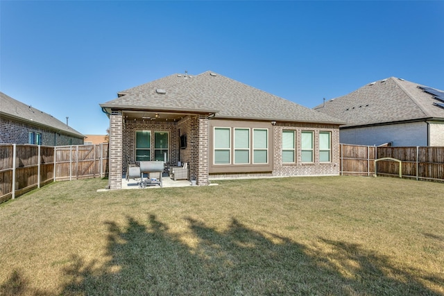 back of house with a patio area and a lawn