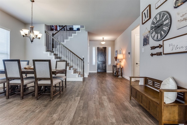 entrance foyer with an inviting chandelier and dark hardwood / wood-style floors