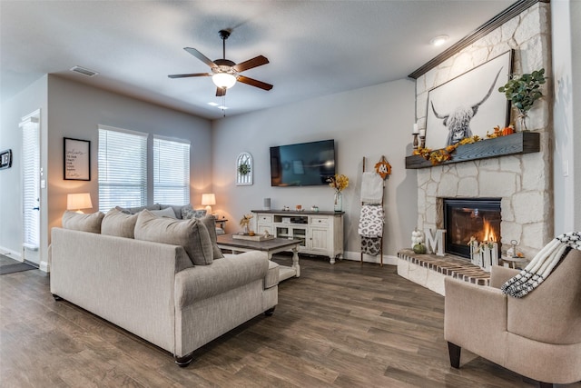 living room with a fireplace, ceiling fan, and dark hardwood / wood-style flooring