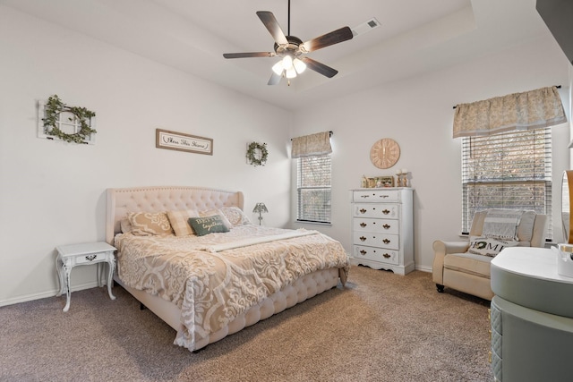 carpeted bedroom featuring multiple windows and ceiling fan