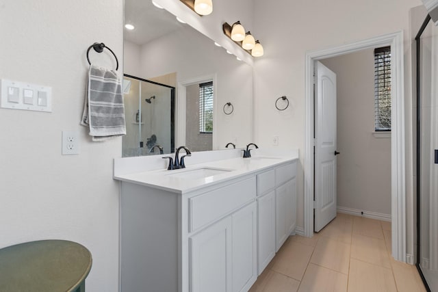 bathroom with an enclosed shower, tile patterned floors, and vanity