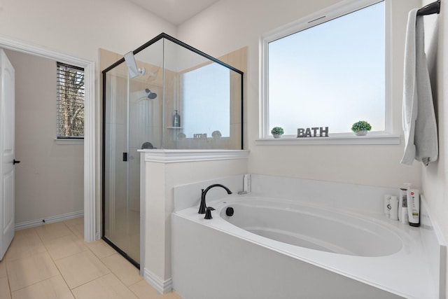 bathroom featuring a wealth of natural light, tile patterned floors, and separate shower and tub