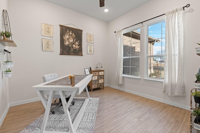 office with light hardwood / wood-style floors and ceiling fan