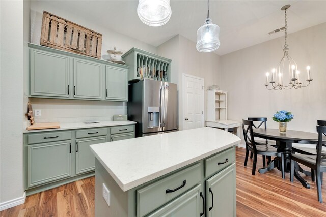 kitchen featuring dishwasher, a center island, sink, and decorative light fixtures