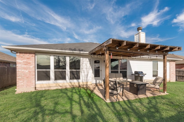 rear view of house with a lawn, outdoor lounge area, and a patio