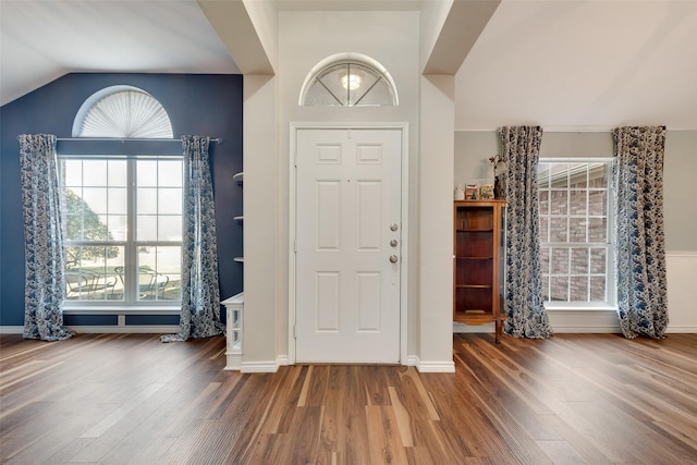 entrance foyer with hardwood / wood-style flooring and vaulted ceiling